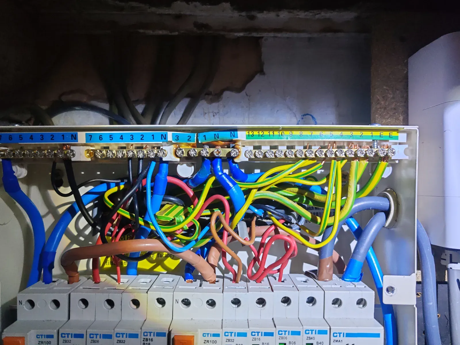 Heat damage and discolouration around busbar terminations in a modern split-load consumer unit — C2 EICR finding
