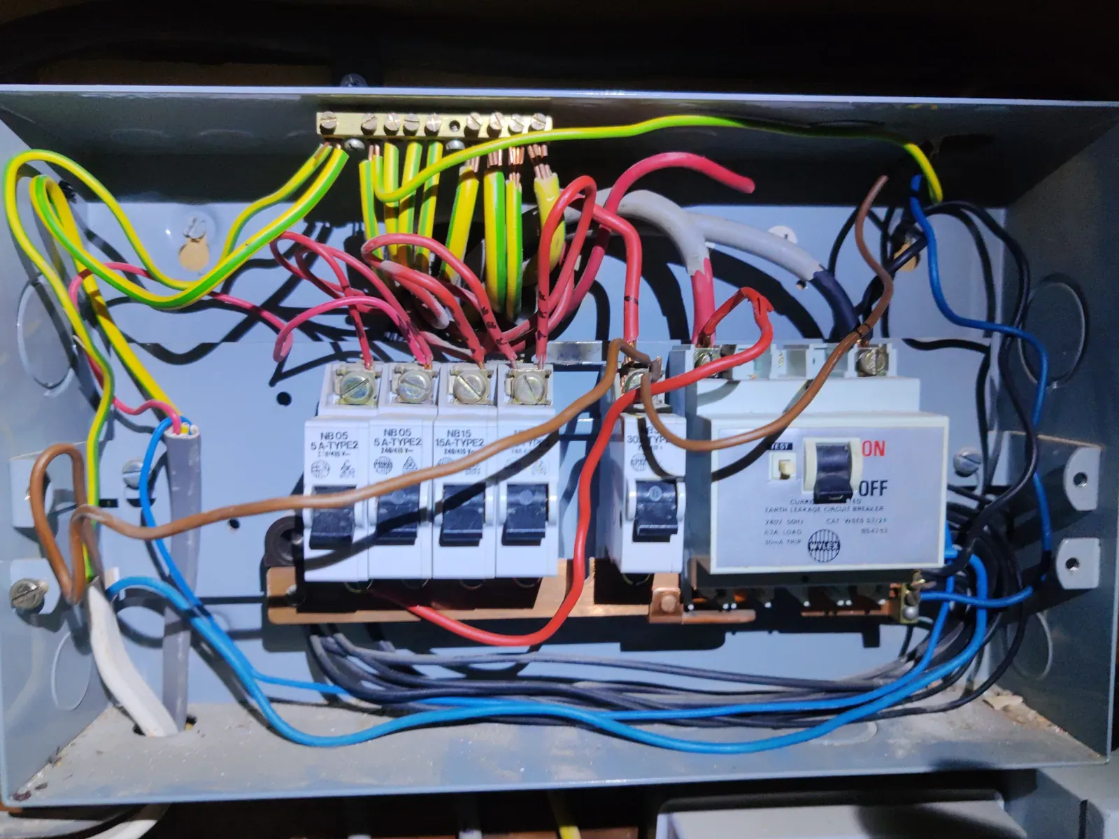 Wylex consumer unit with rewireable fuses and no RCD protection on socket outlet circuits — C2 finding during EICR