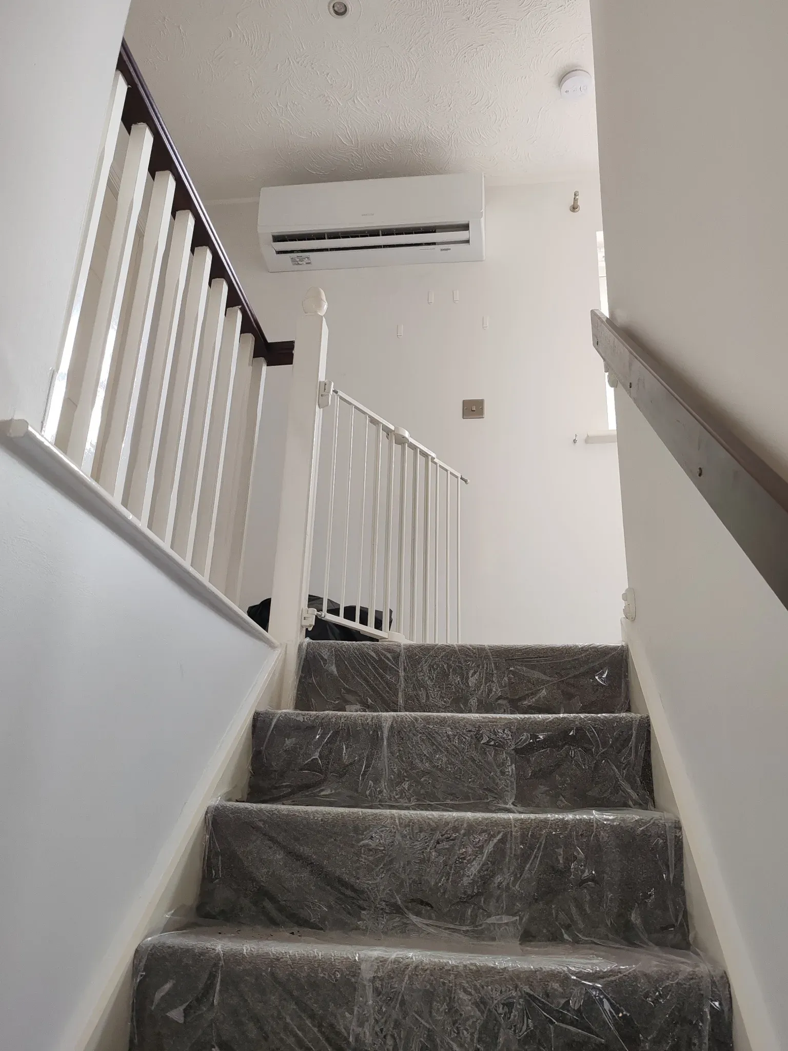 Sinclair Keyon indoor air conditioning unit wall-mounted above an upstairs landing in a Leicester home