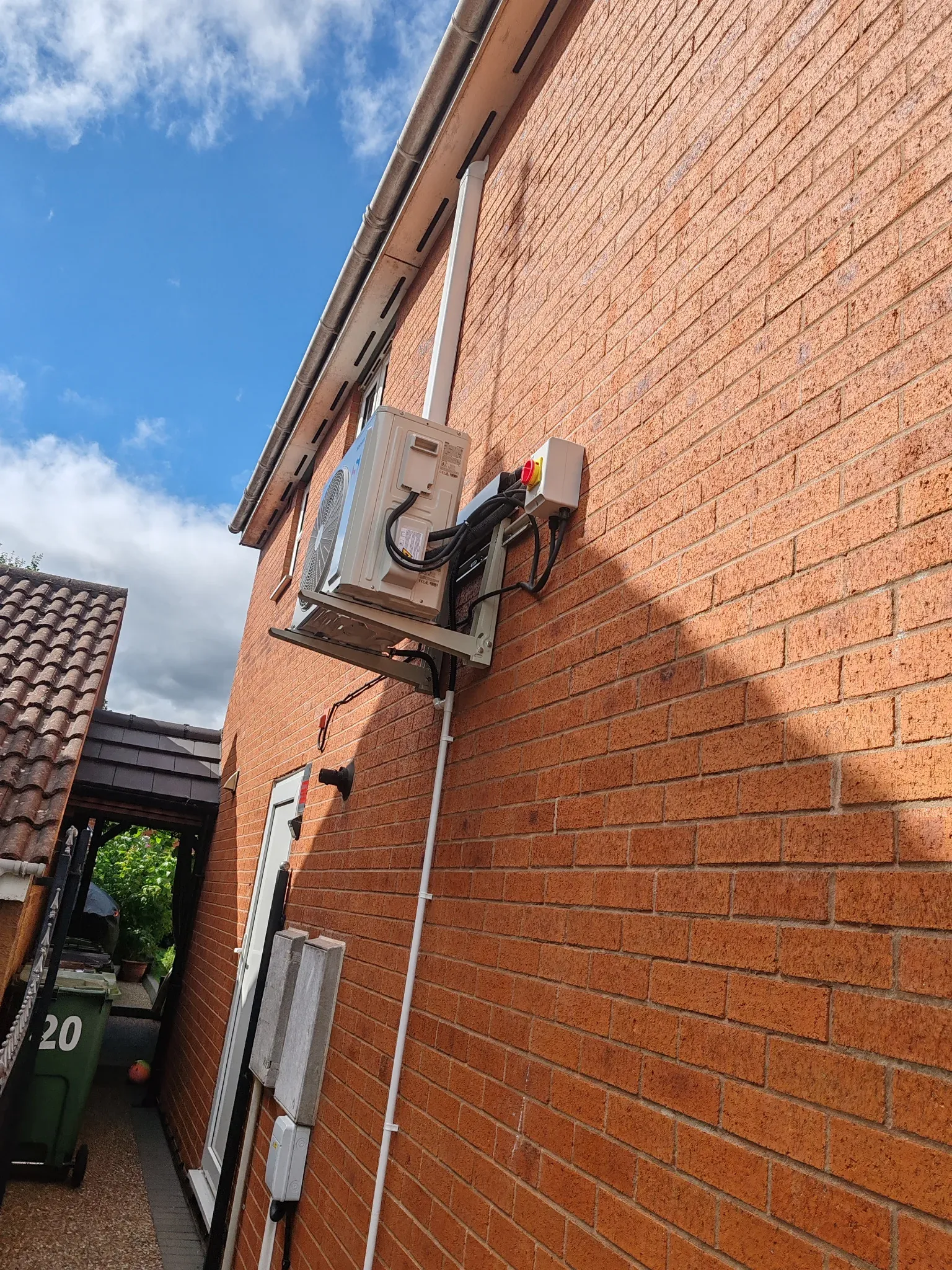 Sinclair Keyon outdoor unit on wall brackets with local isolator and surface-mounted trunking in Leicester